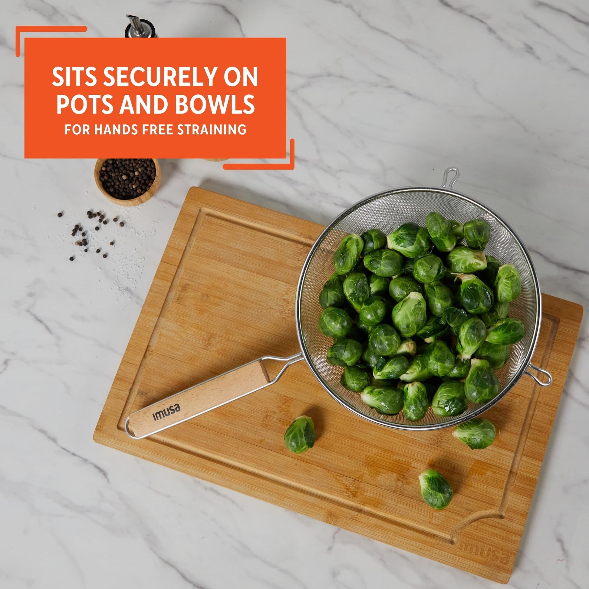 Black 6-inch plastic kitchen strainer by Aura Restored, lightweight and durable for draining and rinsing food.