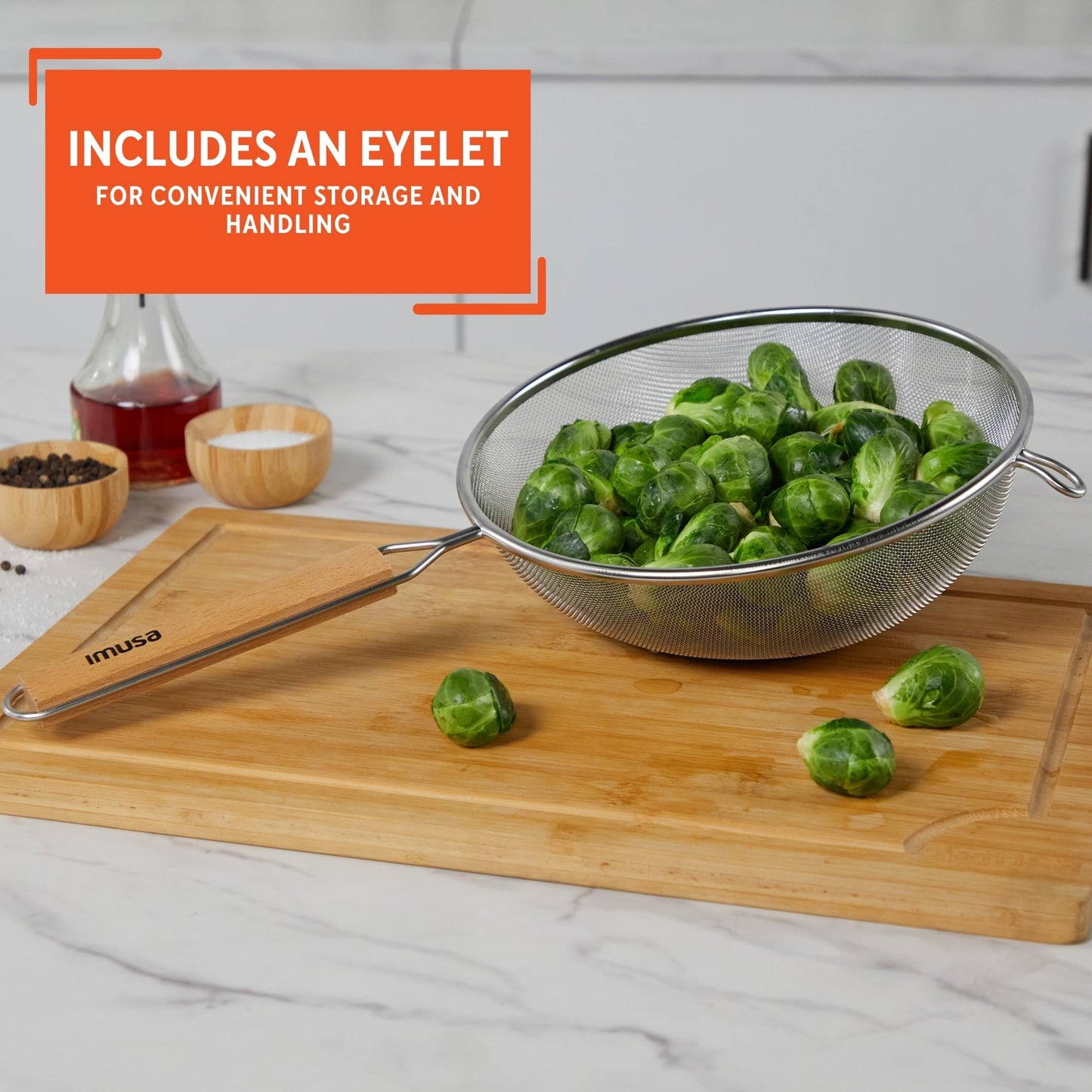 Black 6-inch plastic kitchen strainer by Aura Restored, with fine mesh for draining and sifting in cooking and baking.